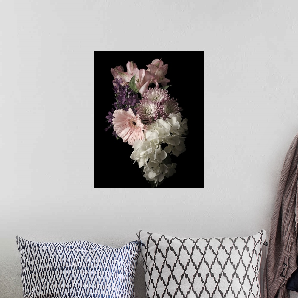 A bohemian room featuring Moody photograph of a bouquet of pastel flowers on black in low light.