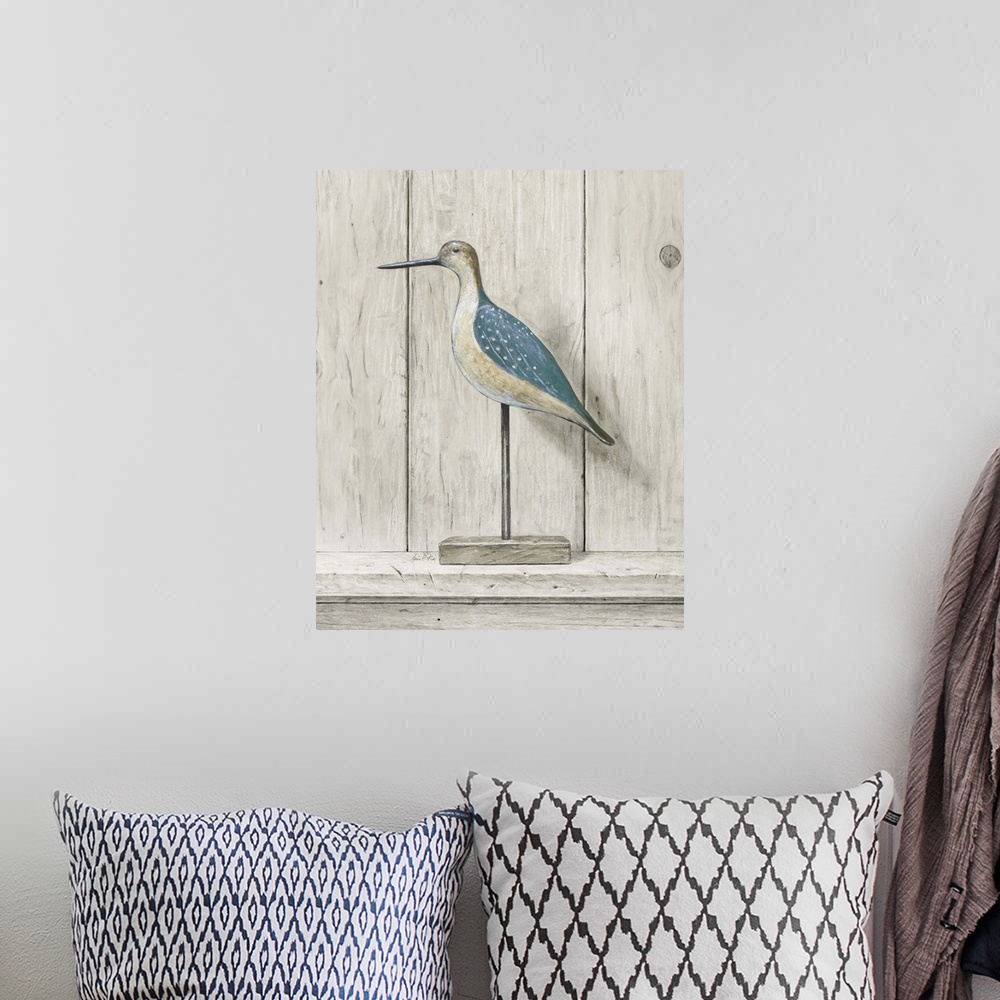 A bohemian room featuring Contemporary coastal themed artwork of a wooden bird statue against a washed wood background.