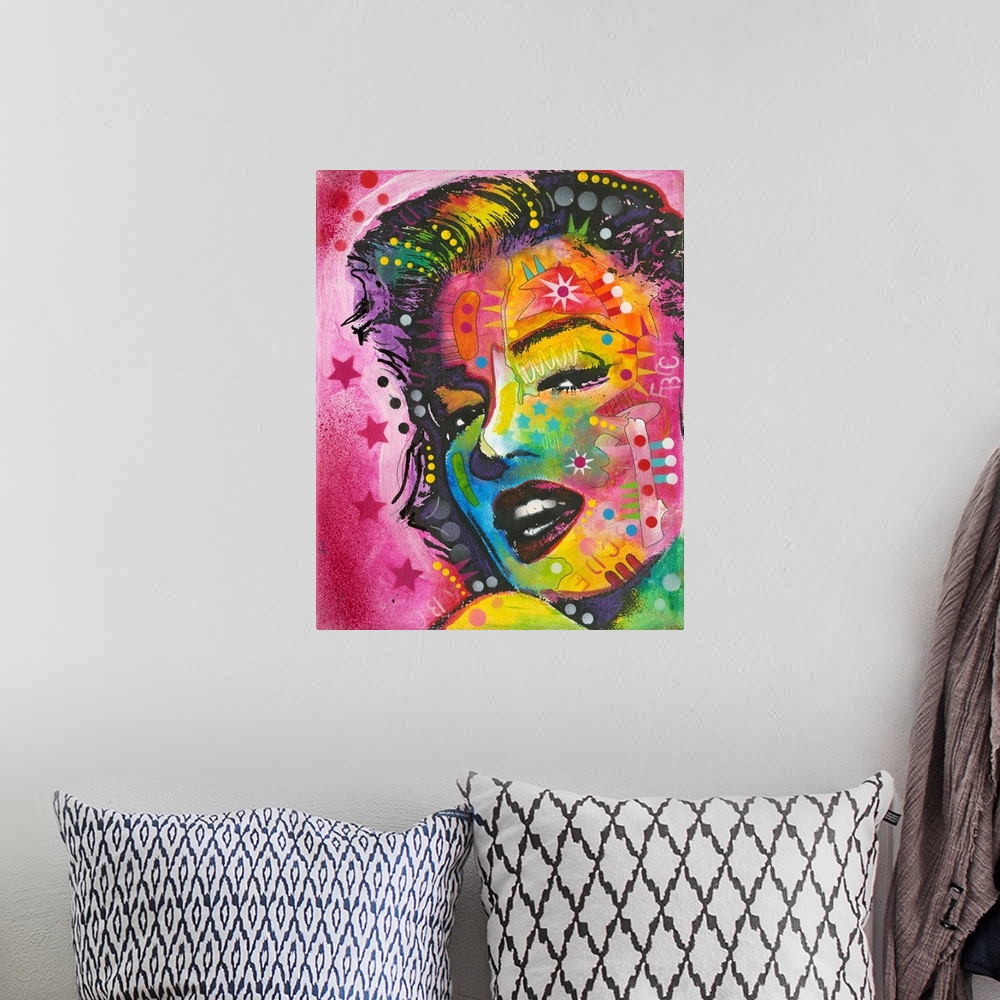 A bohemian room featuring Pop art style painting of Marilyn Monroe with geometric abstract markings on a pink background wi...
