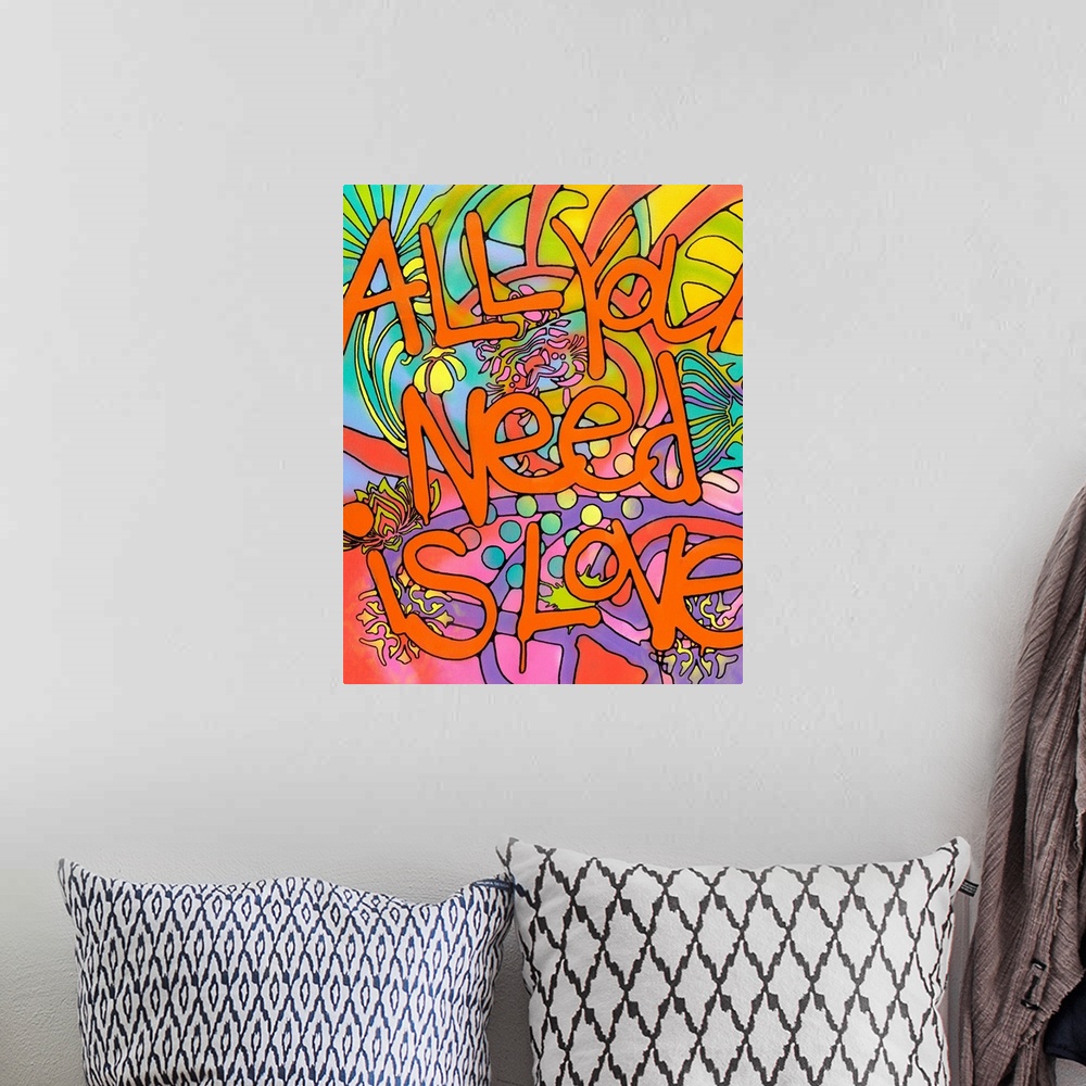 A bohemian room featuring "All You Need is Love" Written in orange bubble letters with paint drips on top of a colorful bac...