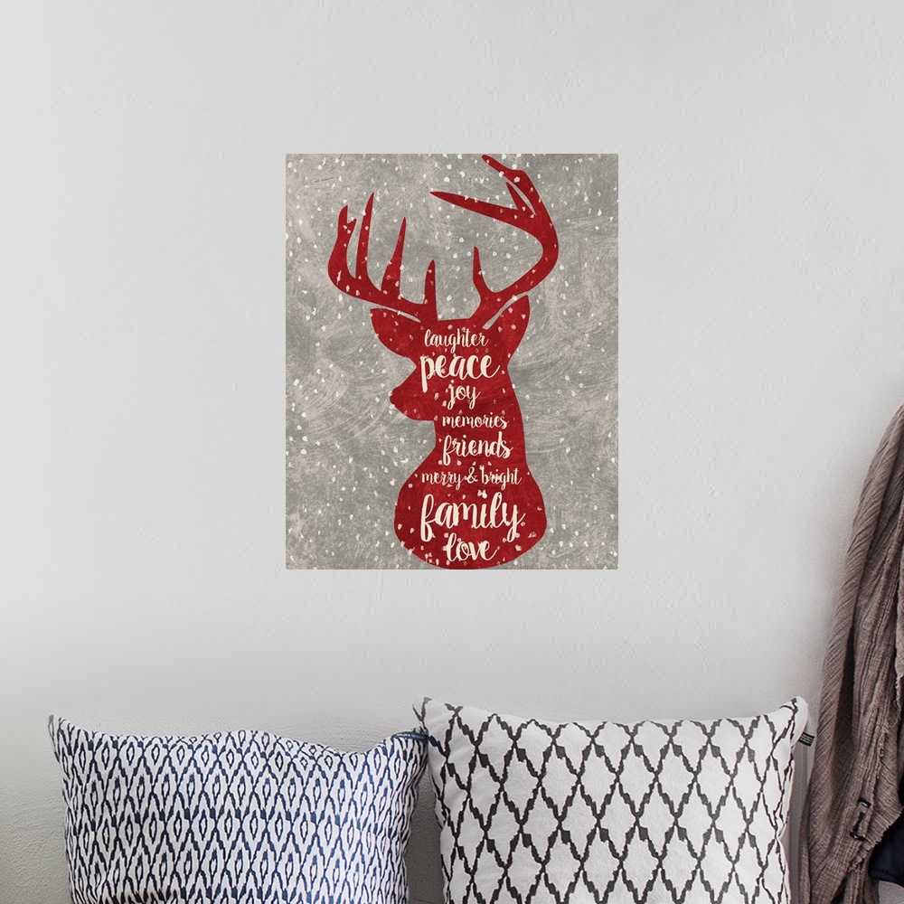 A bohemian room featuring Red reindeer outline with Christmas-themed words handwritten inside.