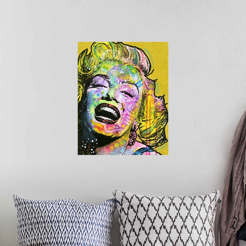 A bohemian room featuring Colorful portrait of Marilyn Monroe with graffiti-like designs on a gold background.