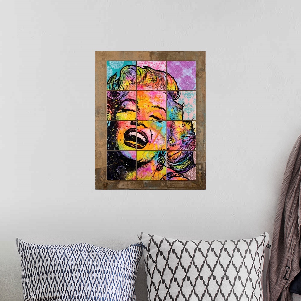 A bohemian room featuring 12 colorful tiles placed together to create Marilyn Monroe's face on top of a brown background wi...