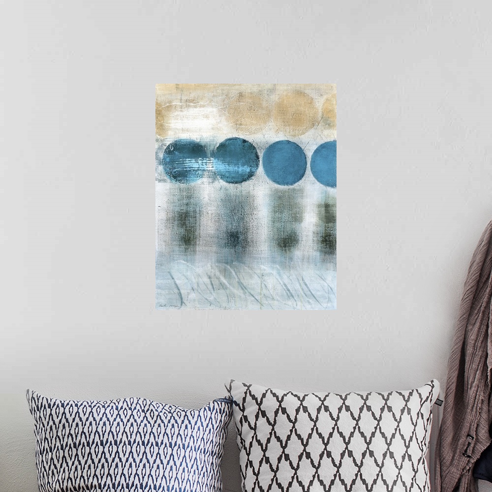 A bohemian room featuring A vertical abstract painting in blue and brown tones with circles and textured strokes.