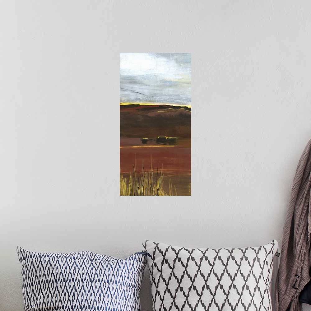 A bohemian room featuring A long vertical painting of an abstract landscape of a prairie field in textured earth tones.