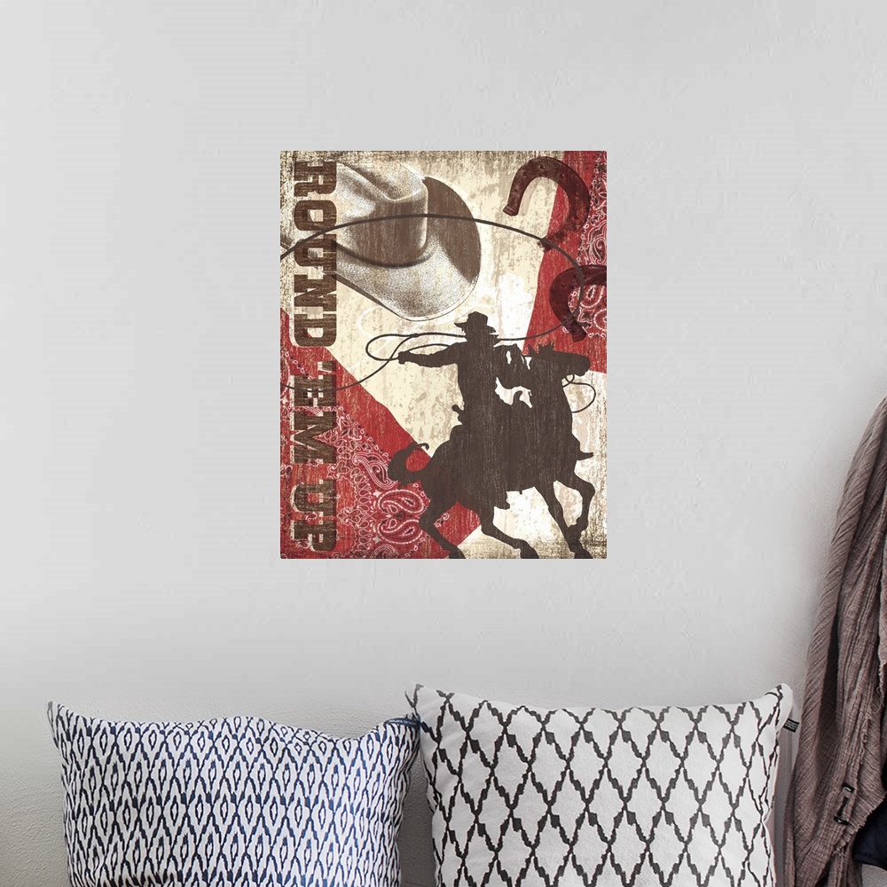 A bohemian room featuring "Round'Em Up" artwork with cowboy hat, horseshoes, bandana and a man riding a horse.