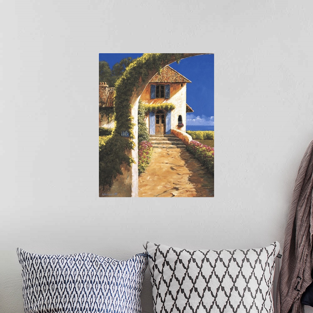 A bohemian room featuring Painting of a house in a rural village with a vine-covered archway.