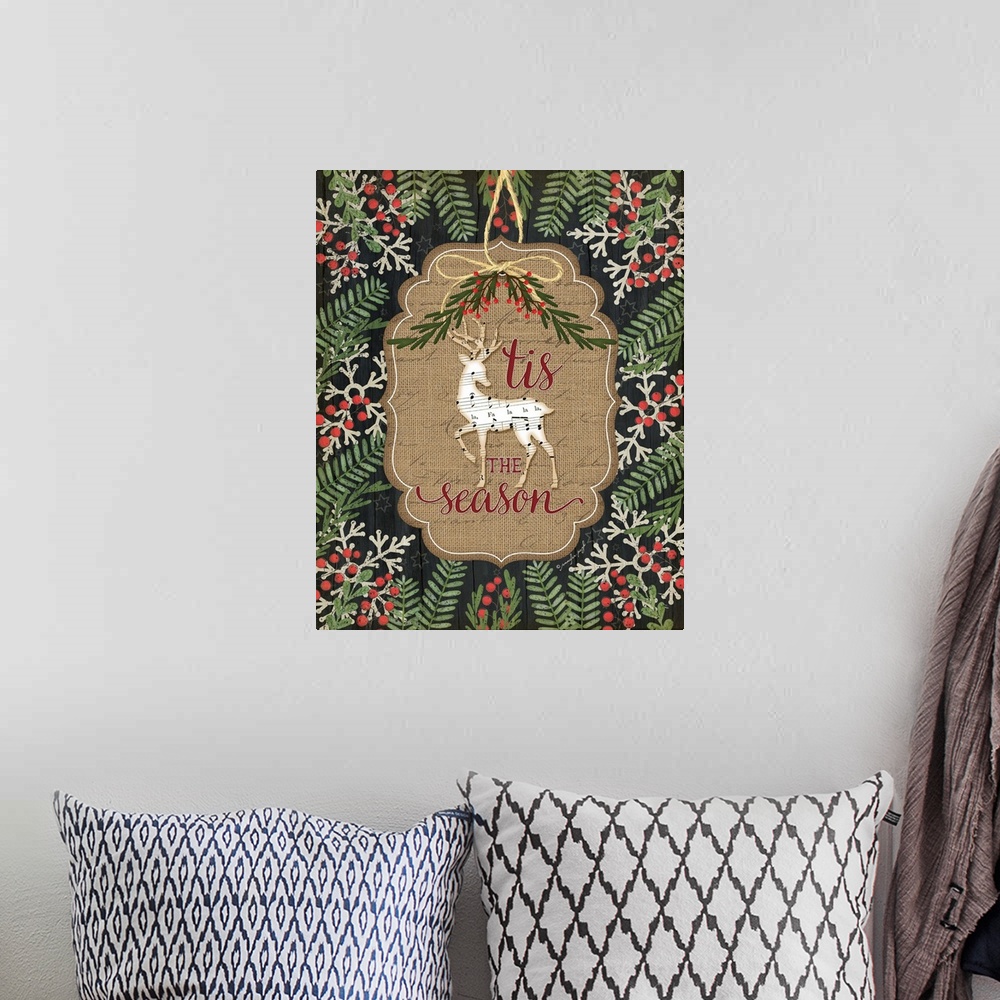 A bohemian room featuring Christmas decor featuring a deer cut out of sheets of music and the words, "'Tis the season" .