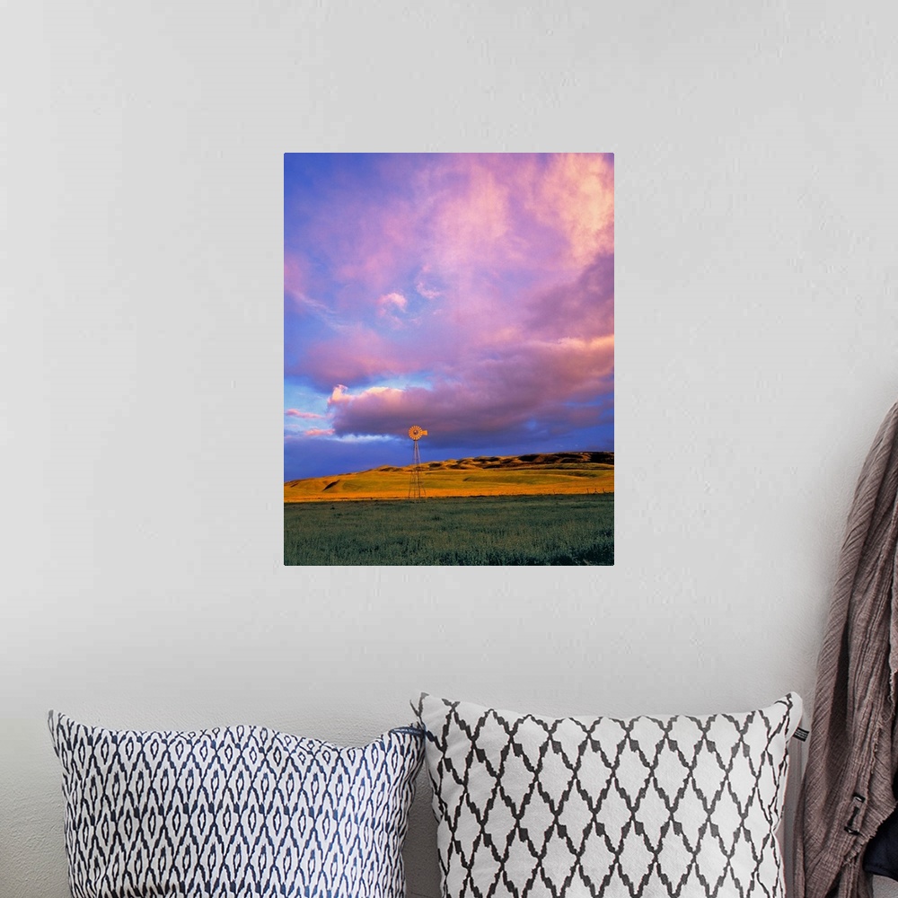 A bohemian room featuring A windmill is dwarfed by enormous violet clouds in Ventura County, California.