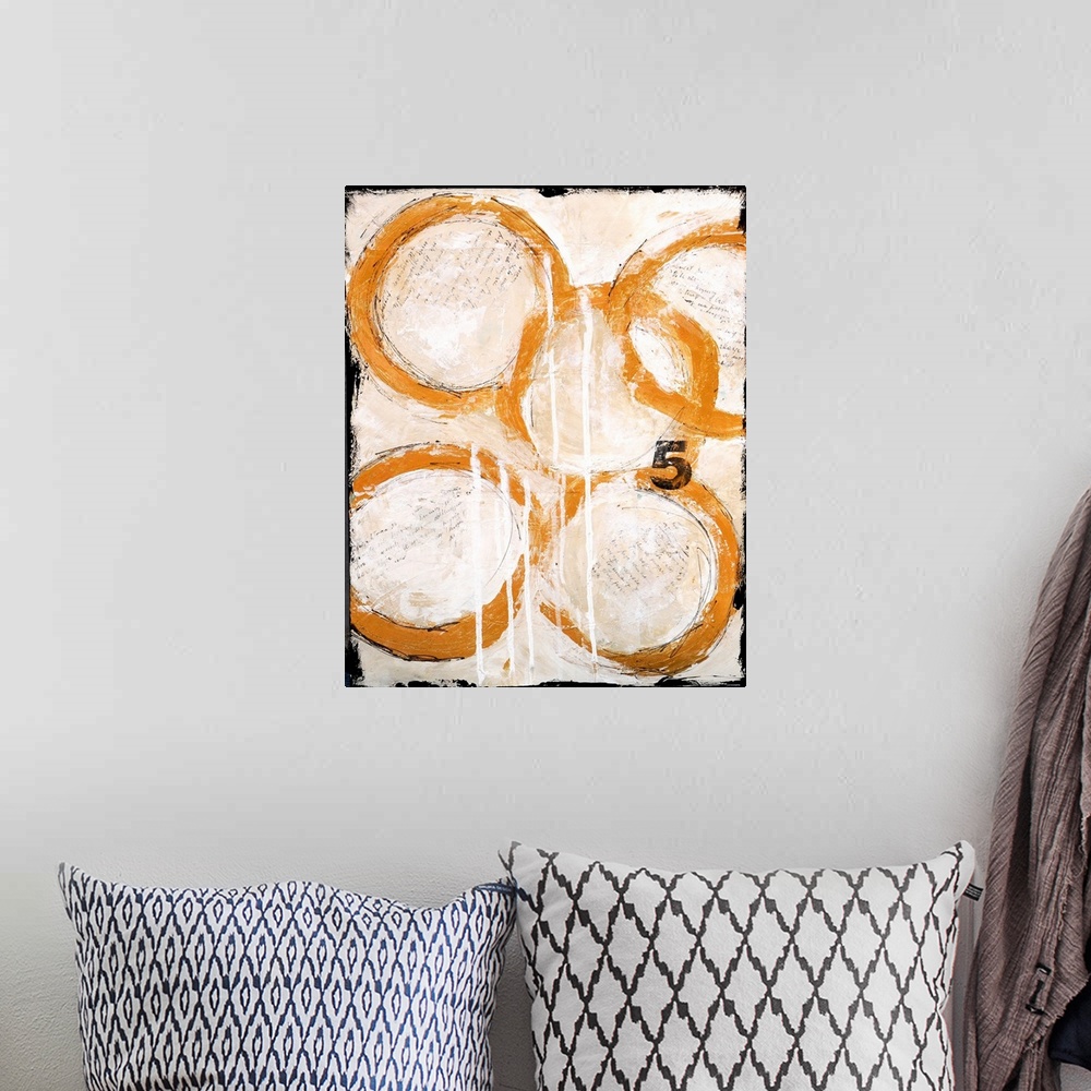 A bohemian room featuring A contemporary abstract painting of five intertwined gold circles and the number five on a cream ...