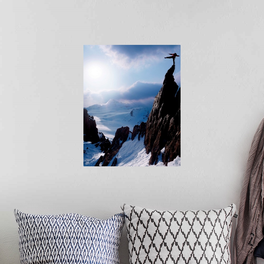 A bohemian room featuring Rock climber at the peak of a snow capped mountain
