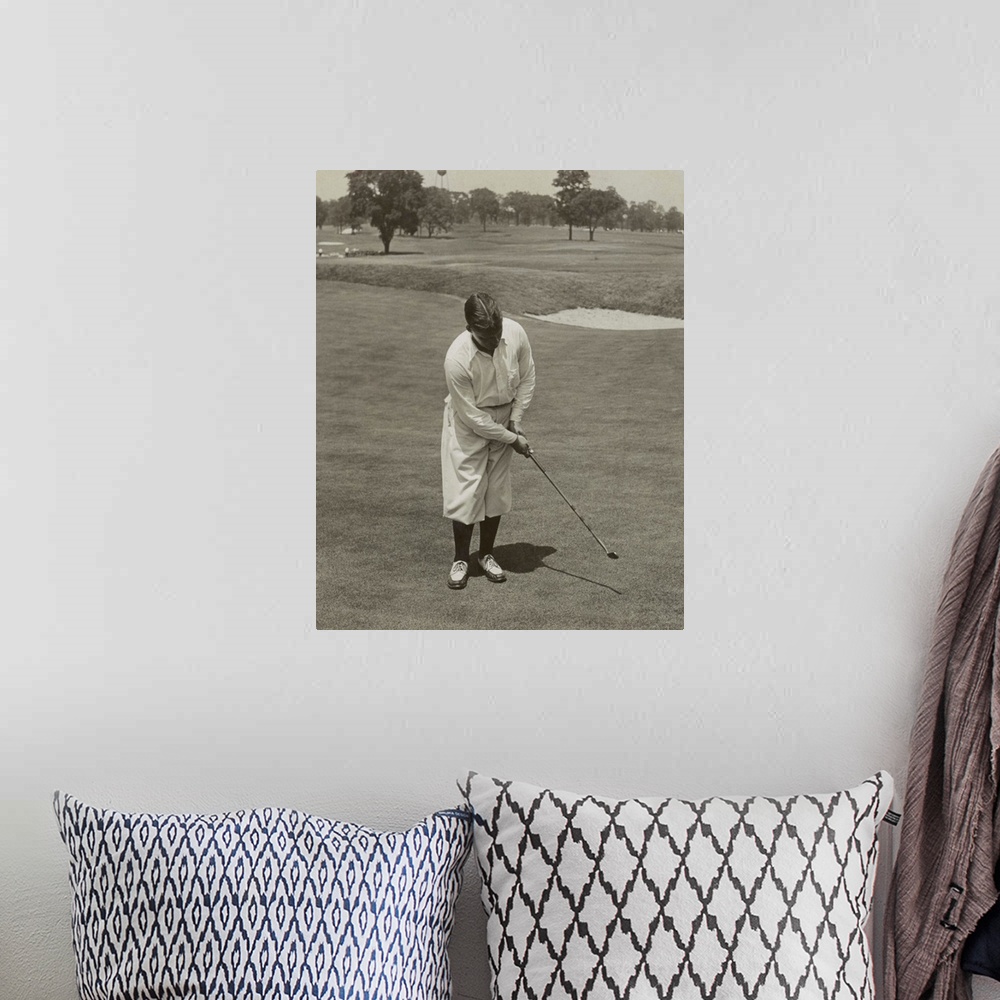 A bohemian room featuring Bobby Jones, winner of 1929 National Open Golf Championship. He is sinking a putt with his famous...