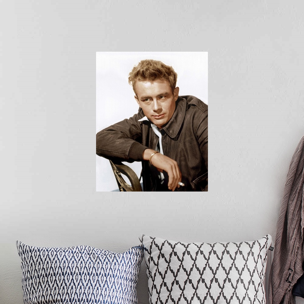 A bohemian room featuring A vintage photograph of the actor James Dean leaning against a chair, to promote his film "Rebel ...
