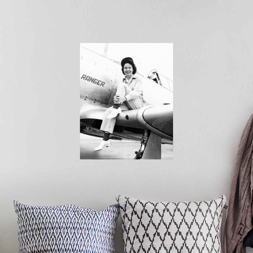 A bohemian room featuring Margaret (Mickey) McGrath, former WASP sitting on the wing of in an XAT-6E trainer aircraft. It w...