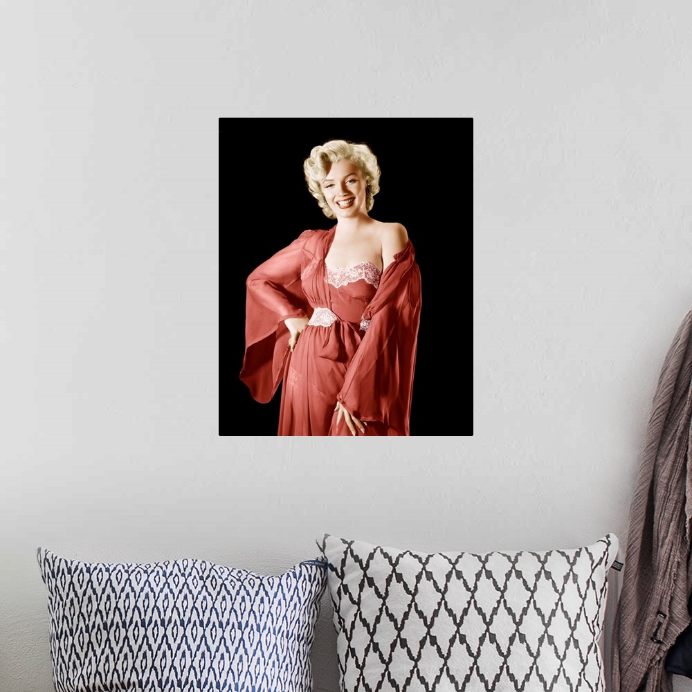 A bohemian room featuring Vintage publicity photograph of Marilyn Monroe, wearing a red robe and dress.