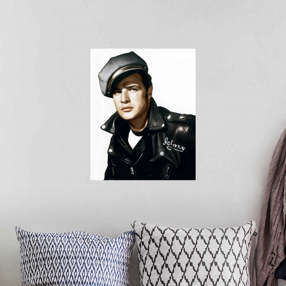 A bohemian room featuring A vintage photograph of Marlon Brando wearing a leather jacket and cap, to promote his movie "The...