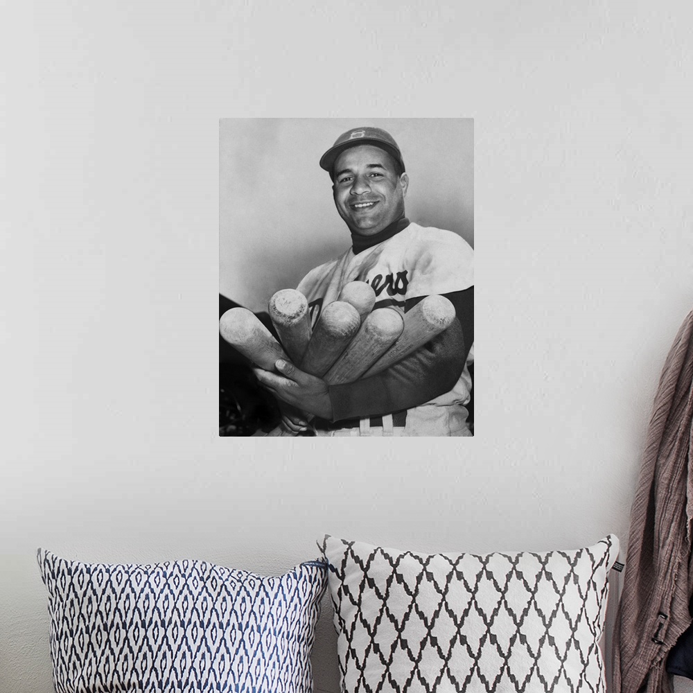A bohemian room featuring Roy Campanella, catcher for the Brooklyn Dodgers, holding six bats, June 4, 1953. He was one of t...