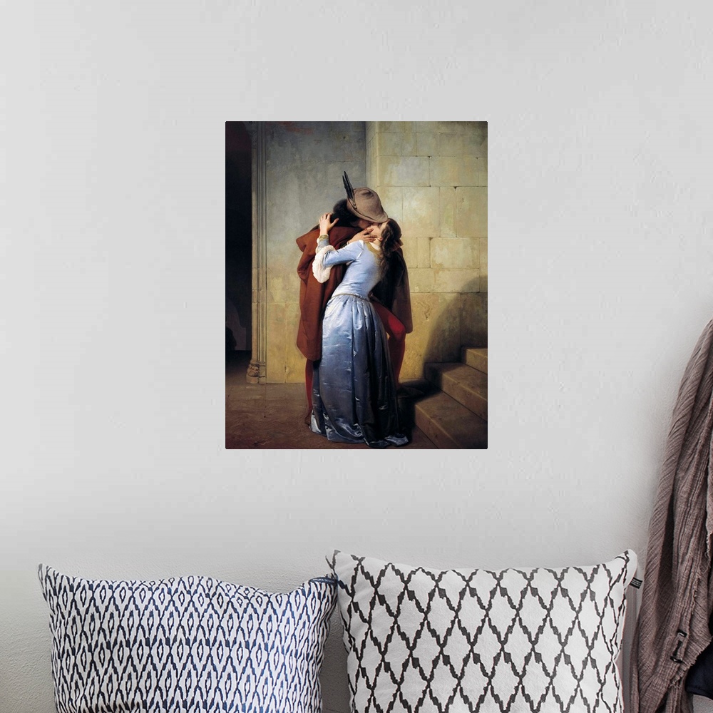 A bohemian room featuring 19th century classic painting of a man kissing a woman in a stone hallway.