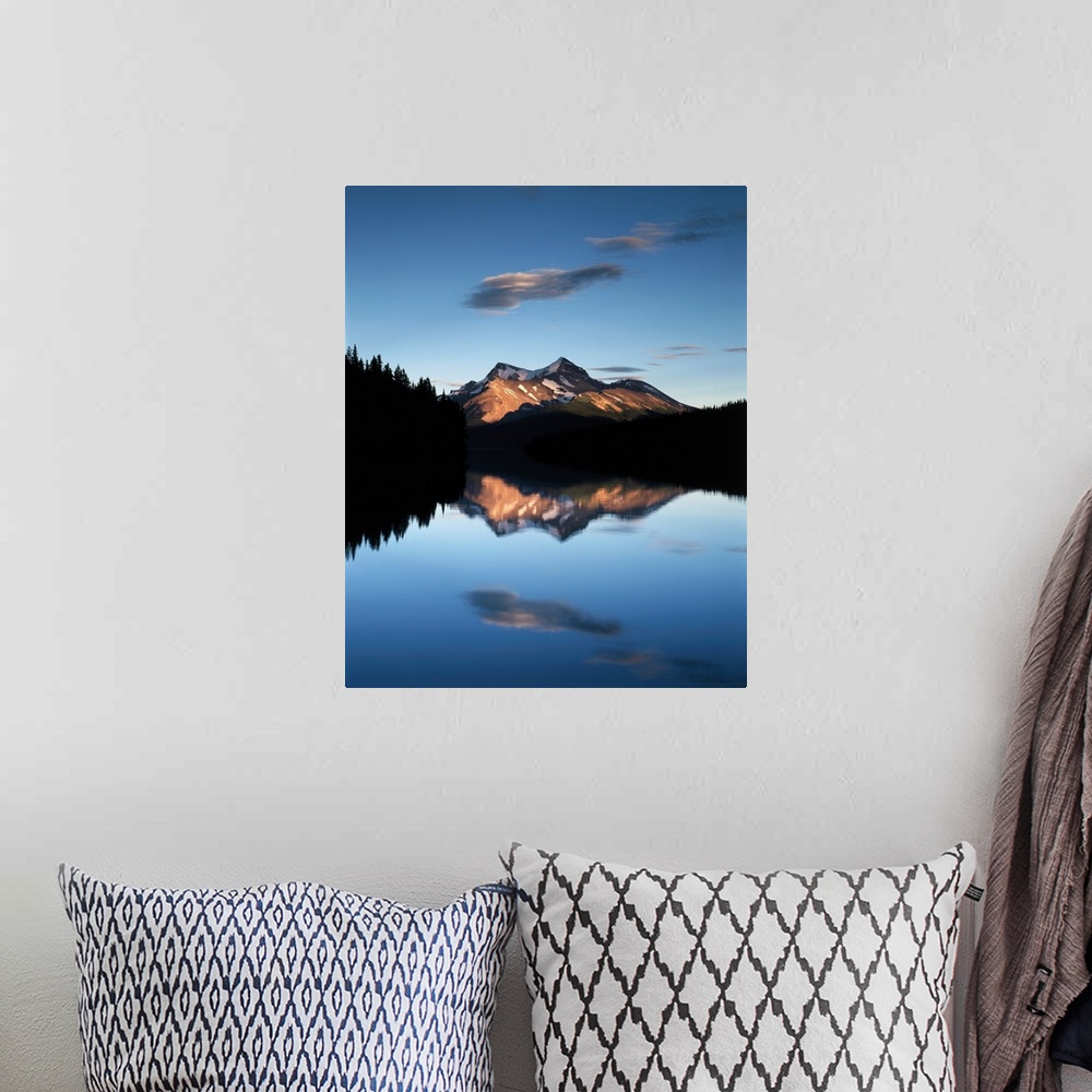 A bohemian room featuring Clouds and sunset light on the mountains reflected in the lake below in Jasper National Park, Alb...