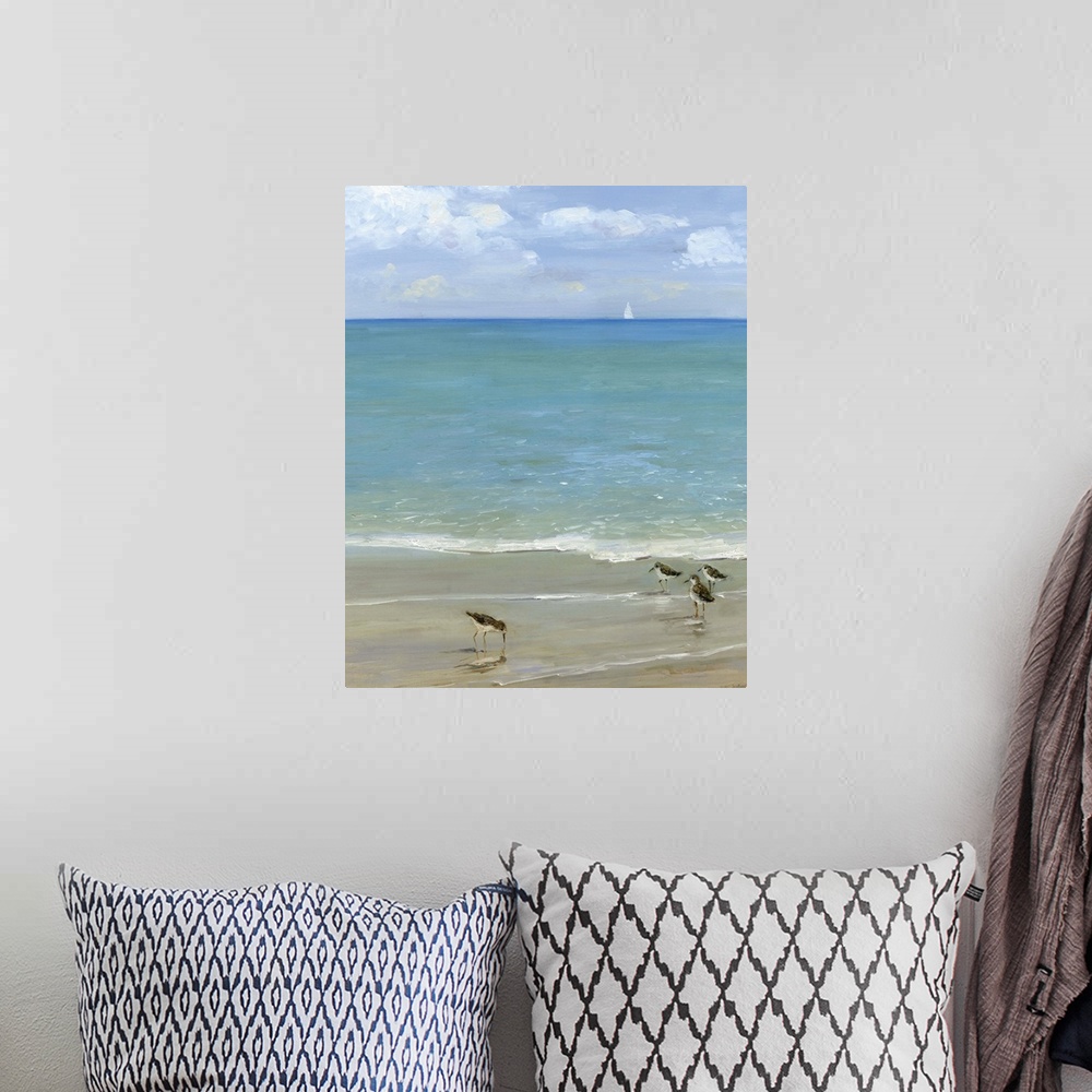 A bohemian room featuring Contemporary painting of the seashore with seabirds in the foreground and a sailboat in the dista...