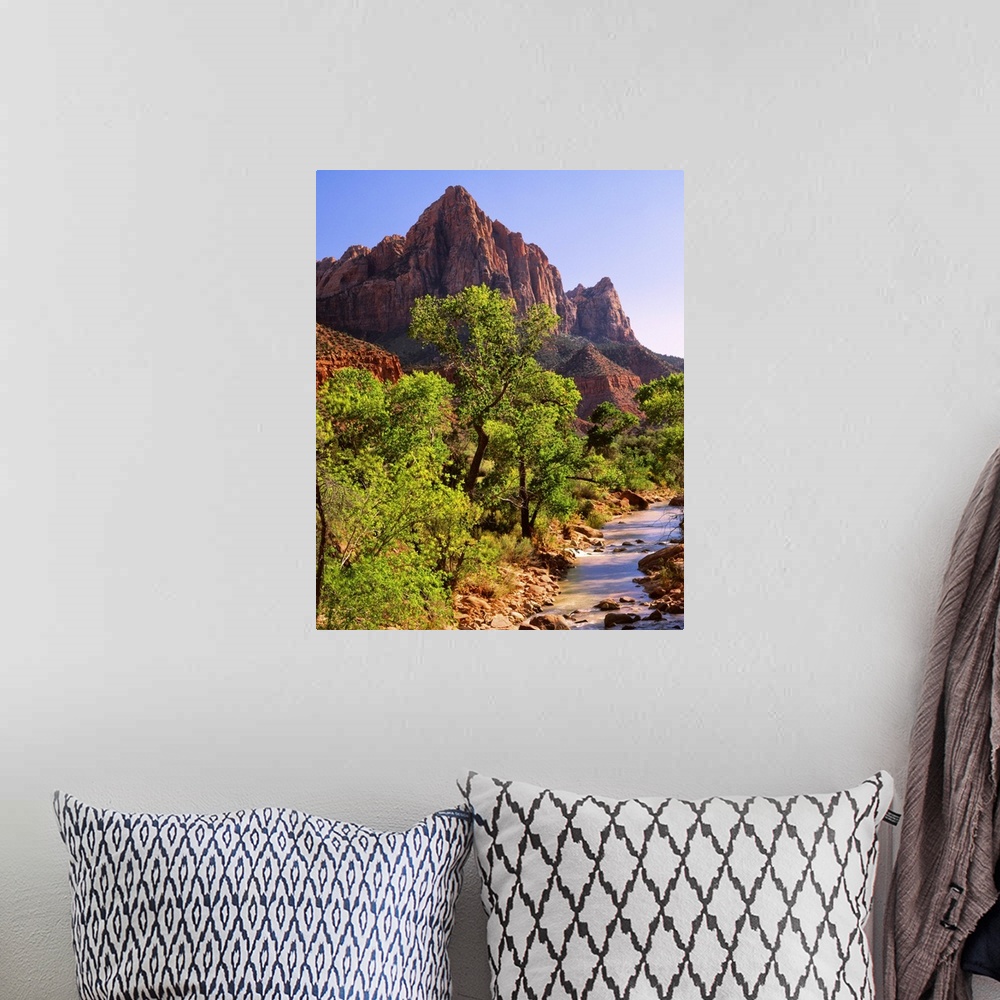 A bohemian room featuring Bright green trees near the red mountains of Zion National Park.