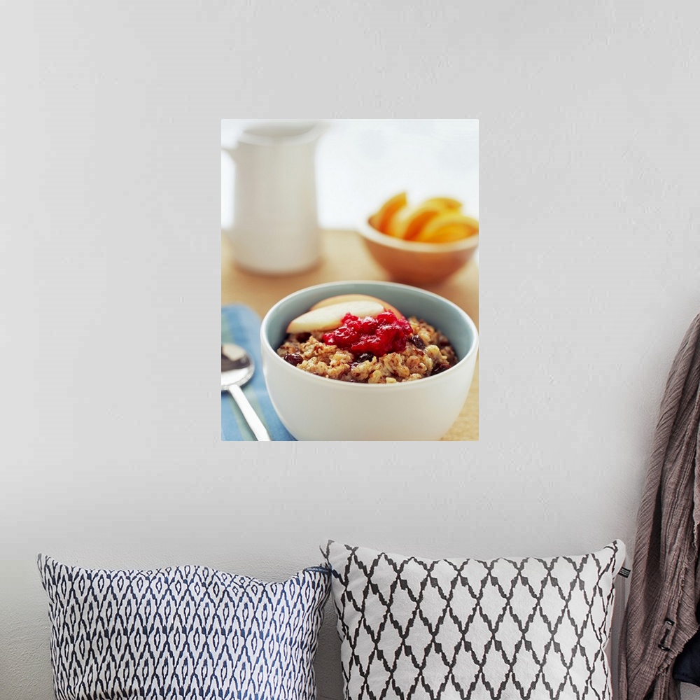 A bohemian room featuring Bowl of raisin, oatmeal with apples and cranberries, close-up