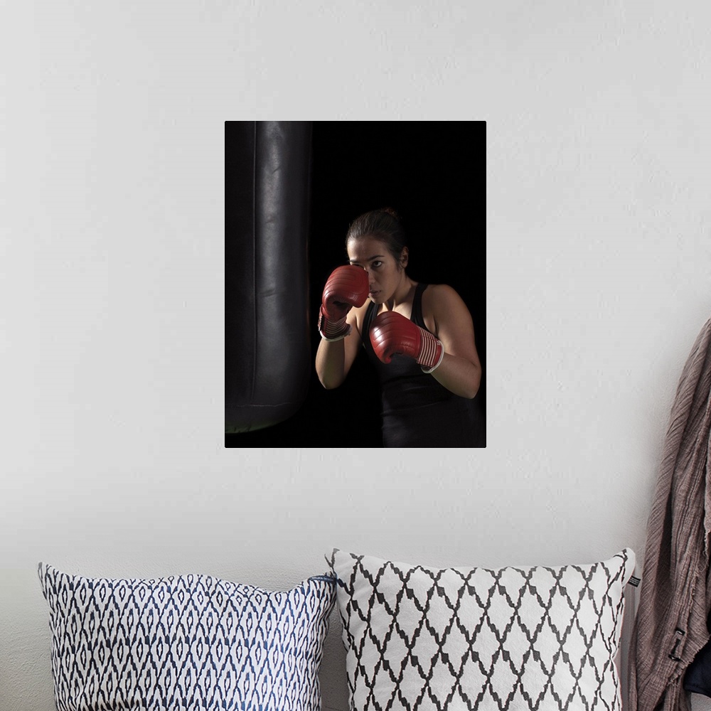 A bohemian room featuring Female boxer training on punching bag