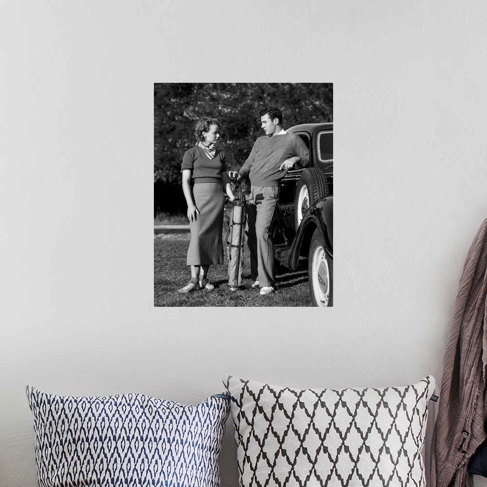 A bohemian room featuring Photo shows a couple seated during a break in playing tennis. Models: Frederick Weidner and Charl...