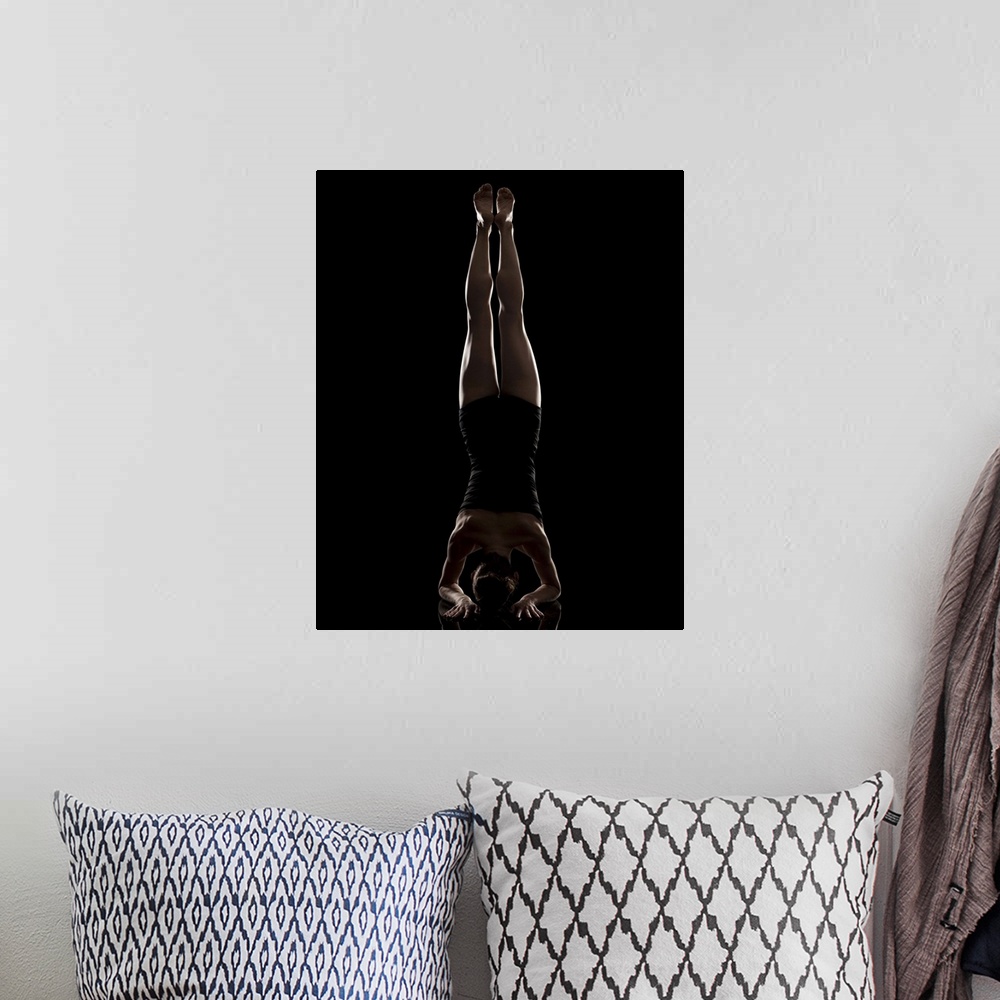 A bohemian room featuring Studio shot of woman practicing yoga.  Headstand Pose, Salamba Sirsasana