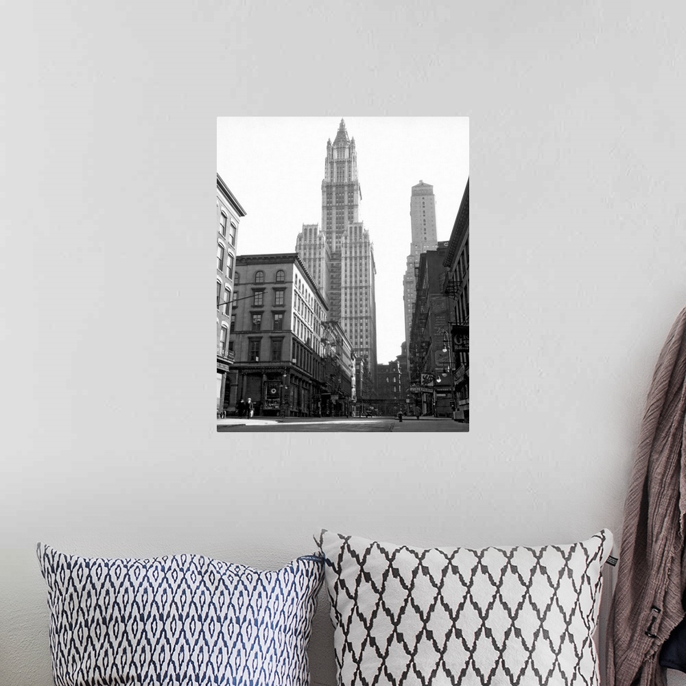 A bohemian room featuring Black and white photograph of a skyscraper in New York City that towers over others surrounding it.