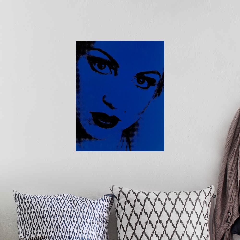 A bohemian room featuring Blue and black pointillism illustration of a close up woman's face.