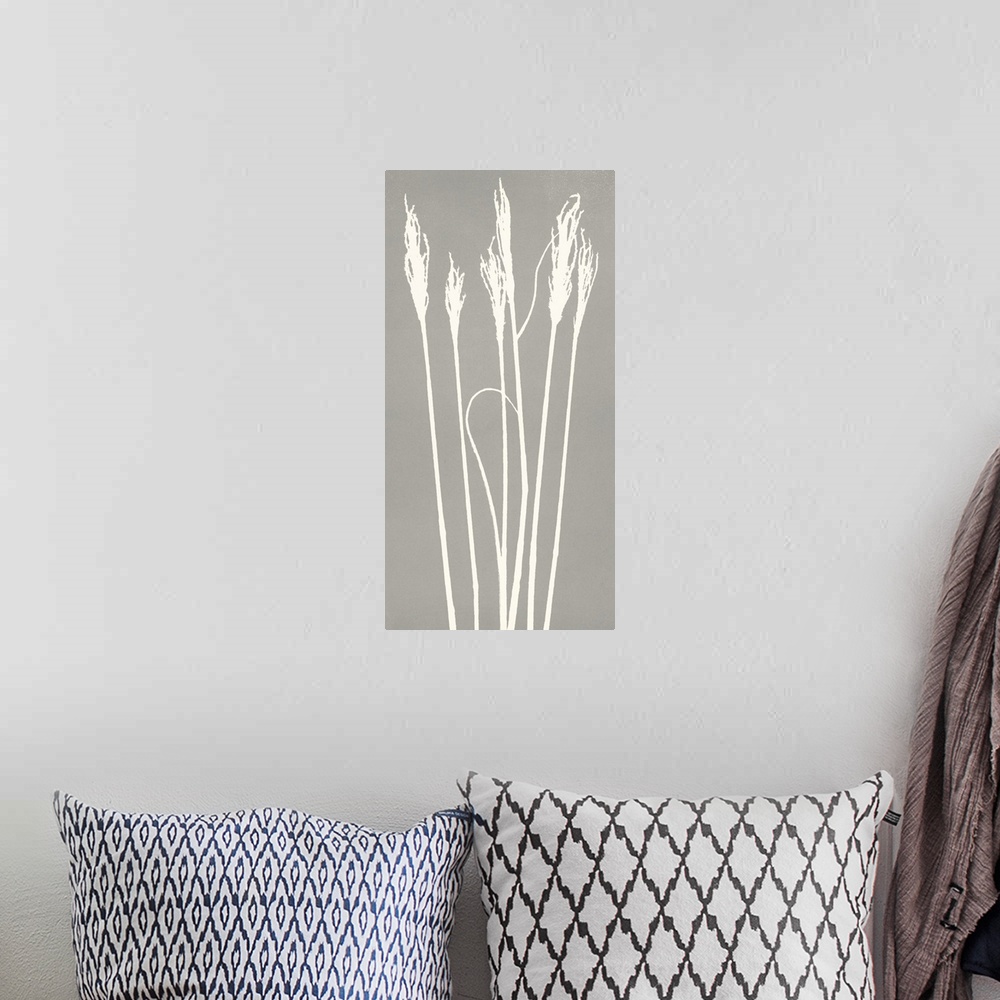 A bohemian room featuring Monoprint image of several wheat stalk silhouettes on a grey background.