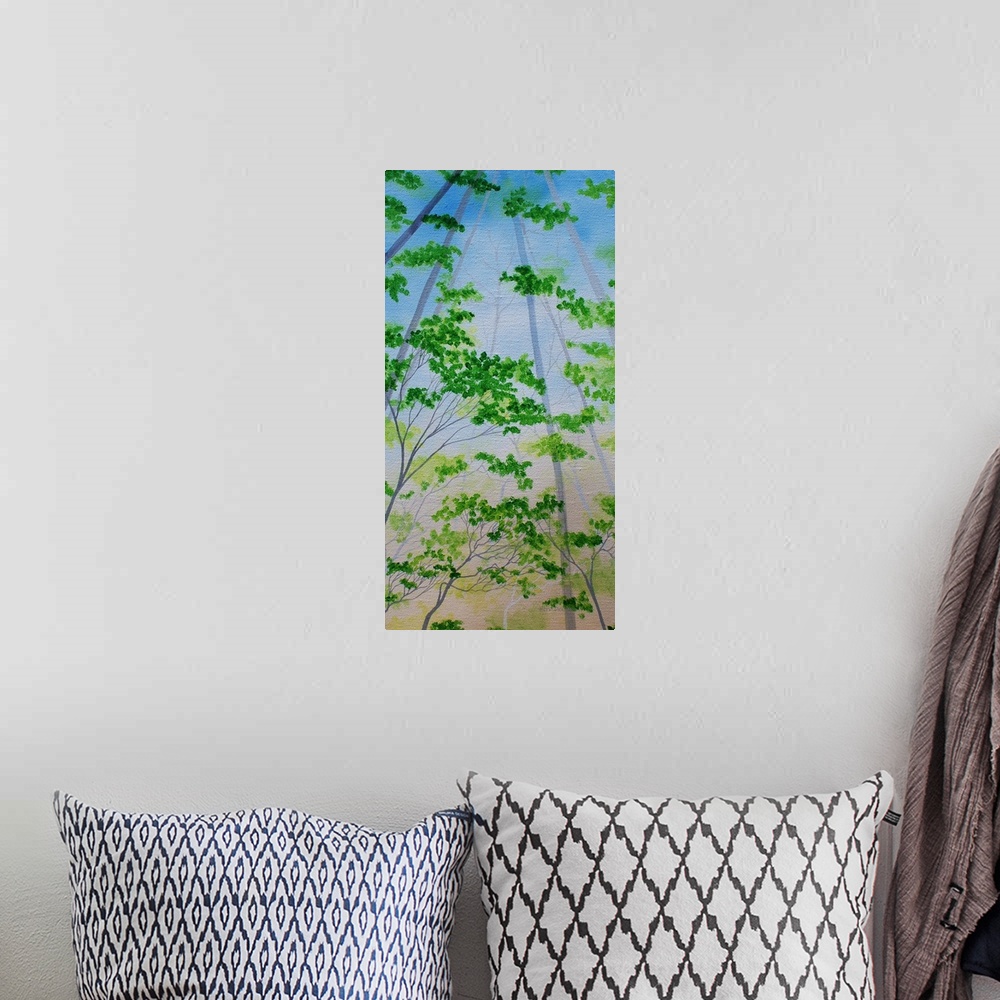 A bohemian room featuring Panel painting of green tree tops with blue skies.