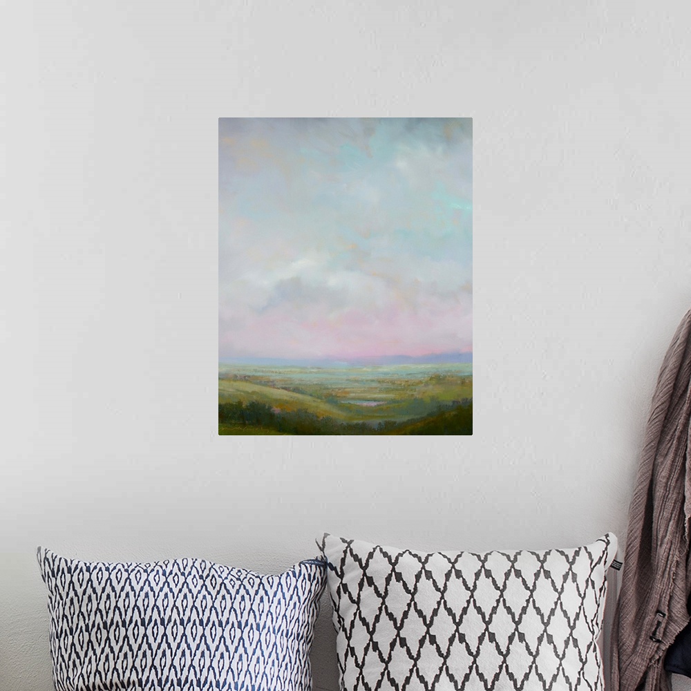 A bohemian room featuring Contemporary landscape painting with cloudy skies above.