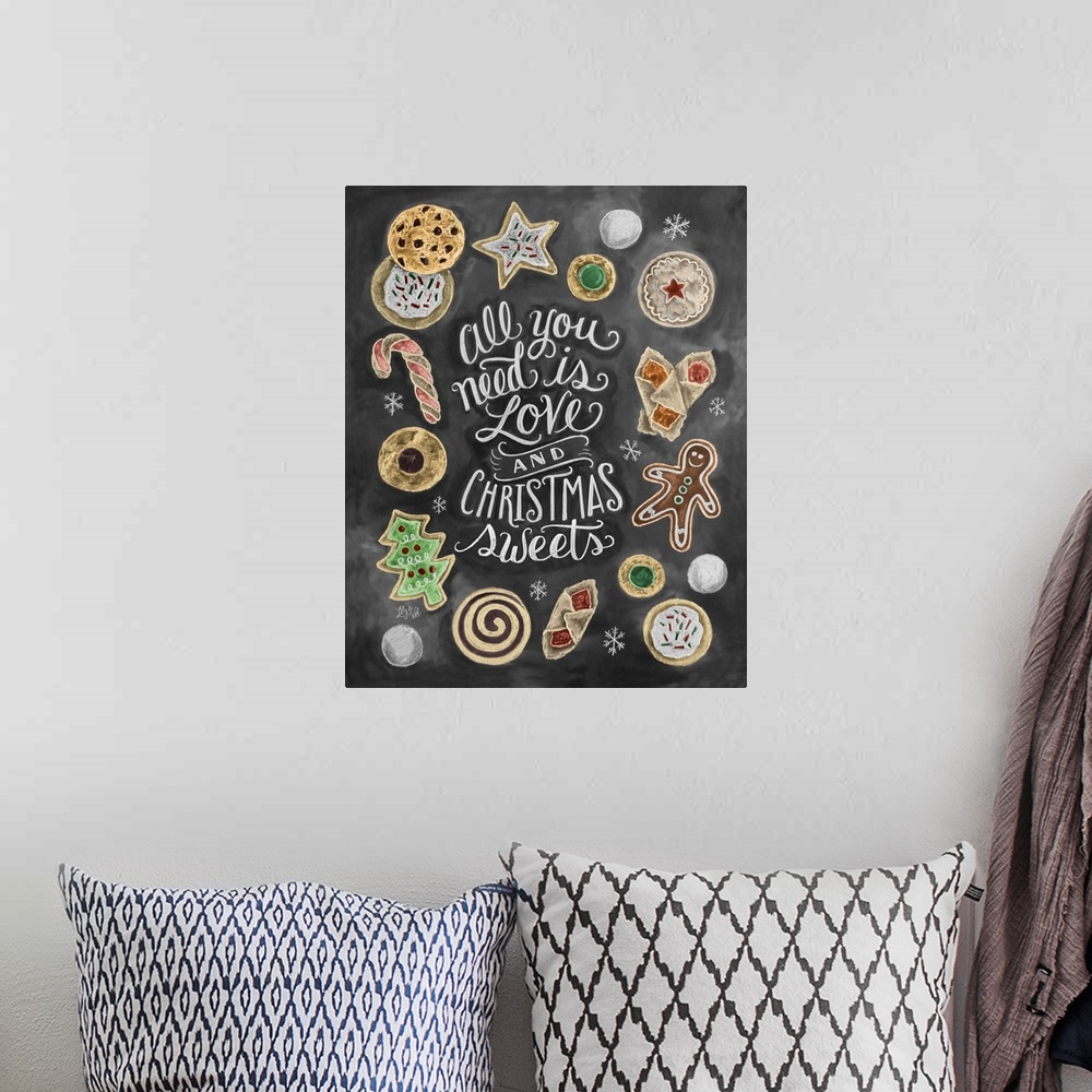 A bohemian room featuring "All you need is love and Christmas sweets" handwritten in chalk and decorated with drawings of c...