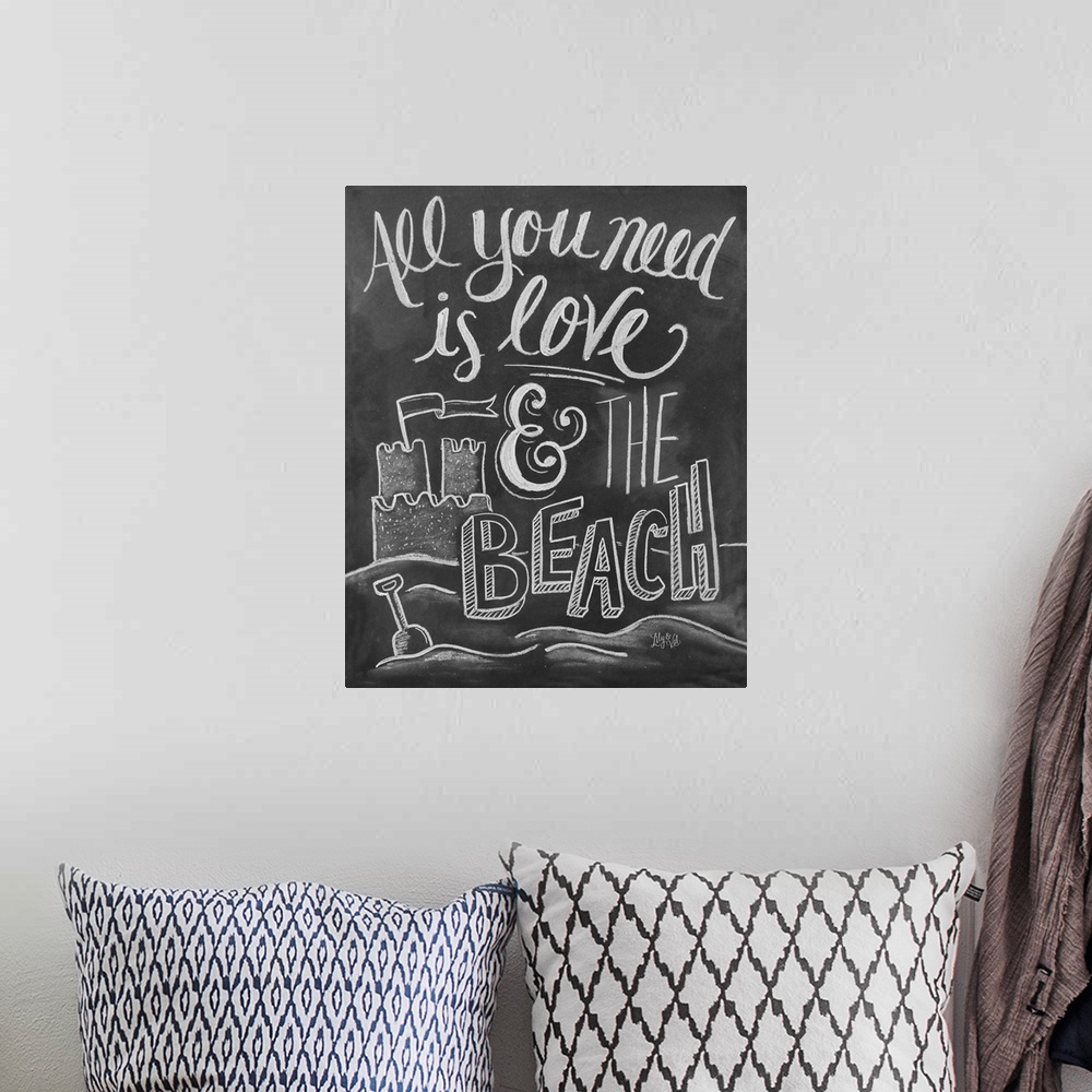 A bohemian room featuring "All you need is love and the beach" handwritten with a drawing of a sand castle.