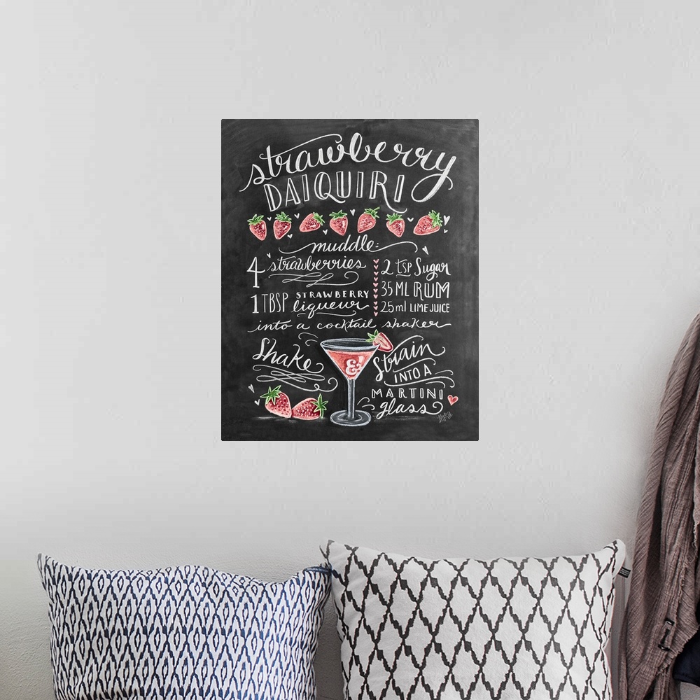 A bohemian room featuring Handlettered recipe for a Strawberry Daquiri cocktail with the appearance of a chalkboard drawing.