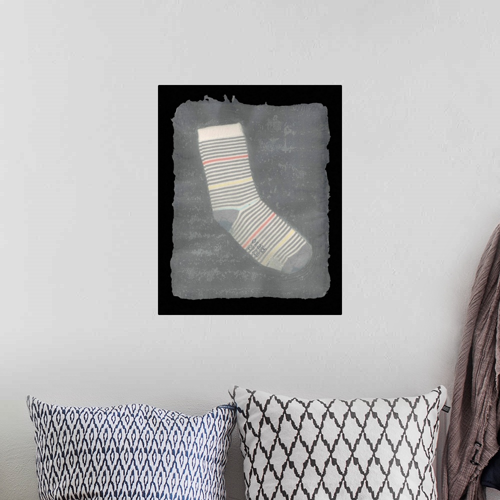 A bohemian room featuring A worn, striped children's sock suspended in handmade paper.