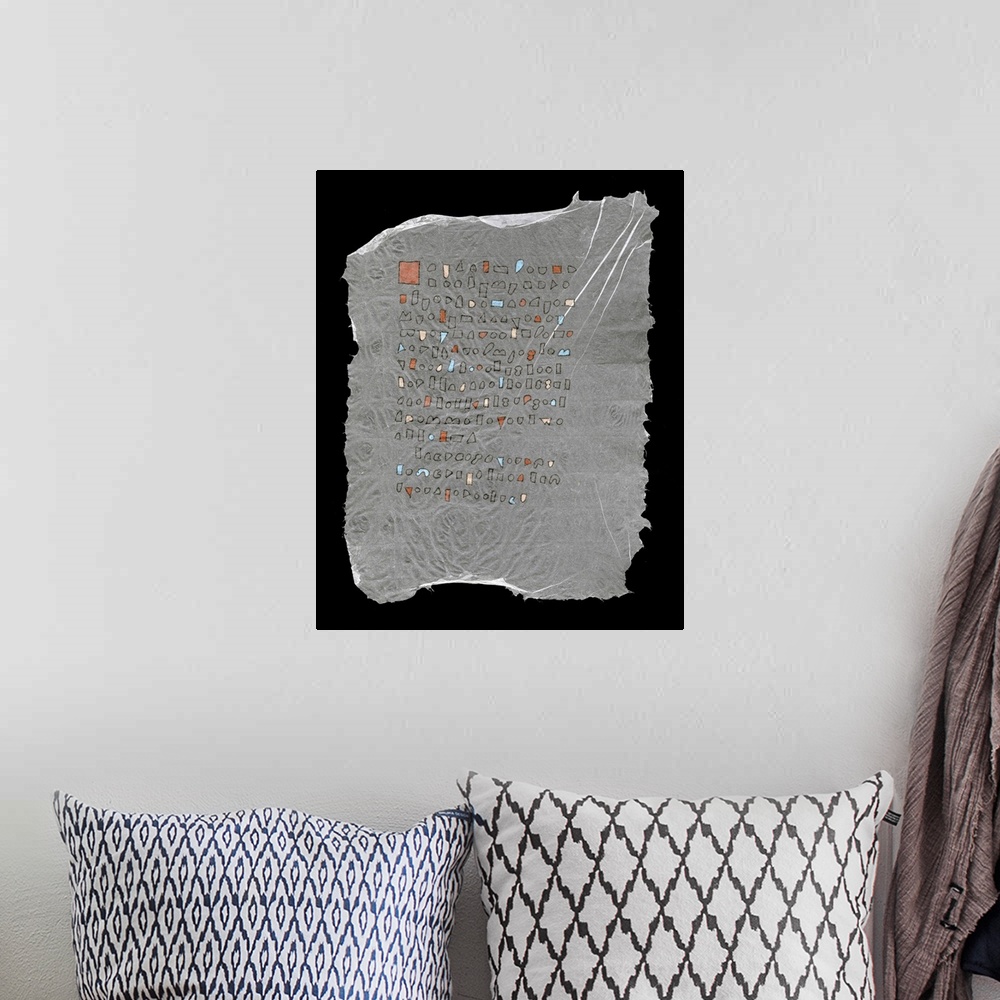 A bohemian room featuring Geometric shapes resembling text line up on handmade paper with great character.