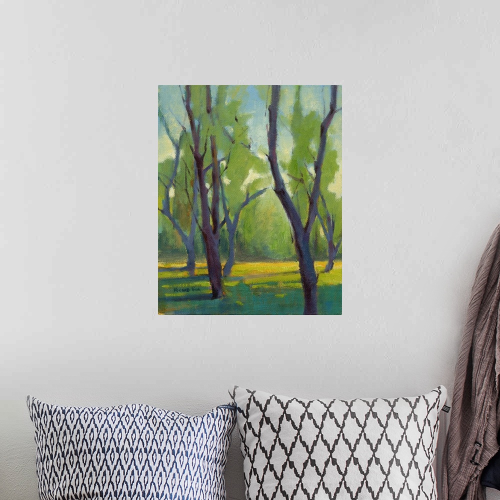 A bohemian room featuring Vertical painting of bare trees.