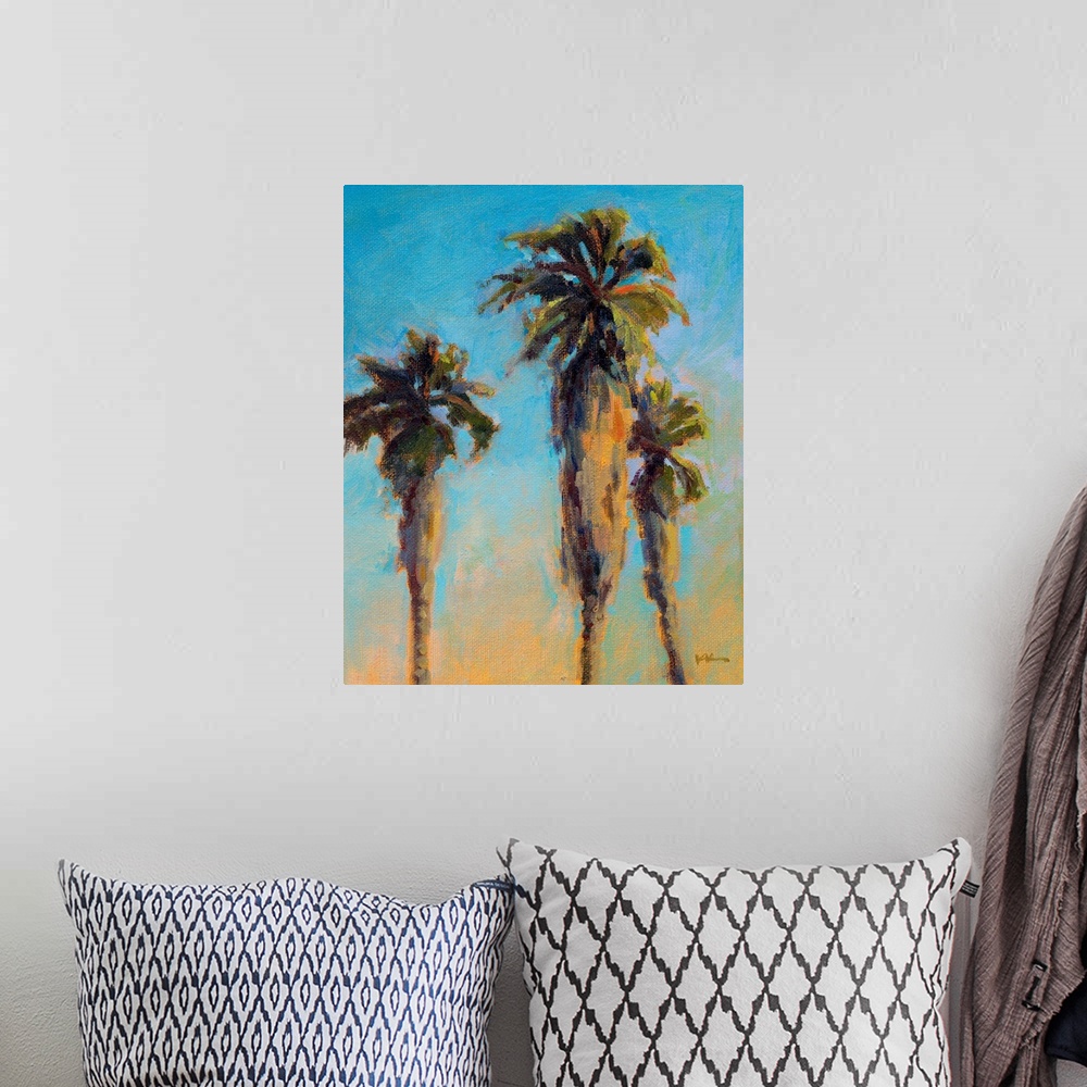 A bohemian room featuring A vertical painting of palm trees.