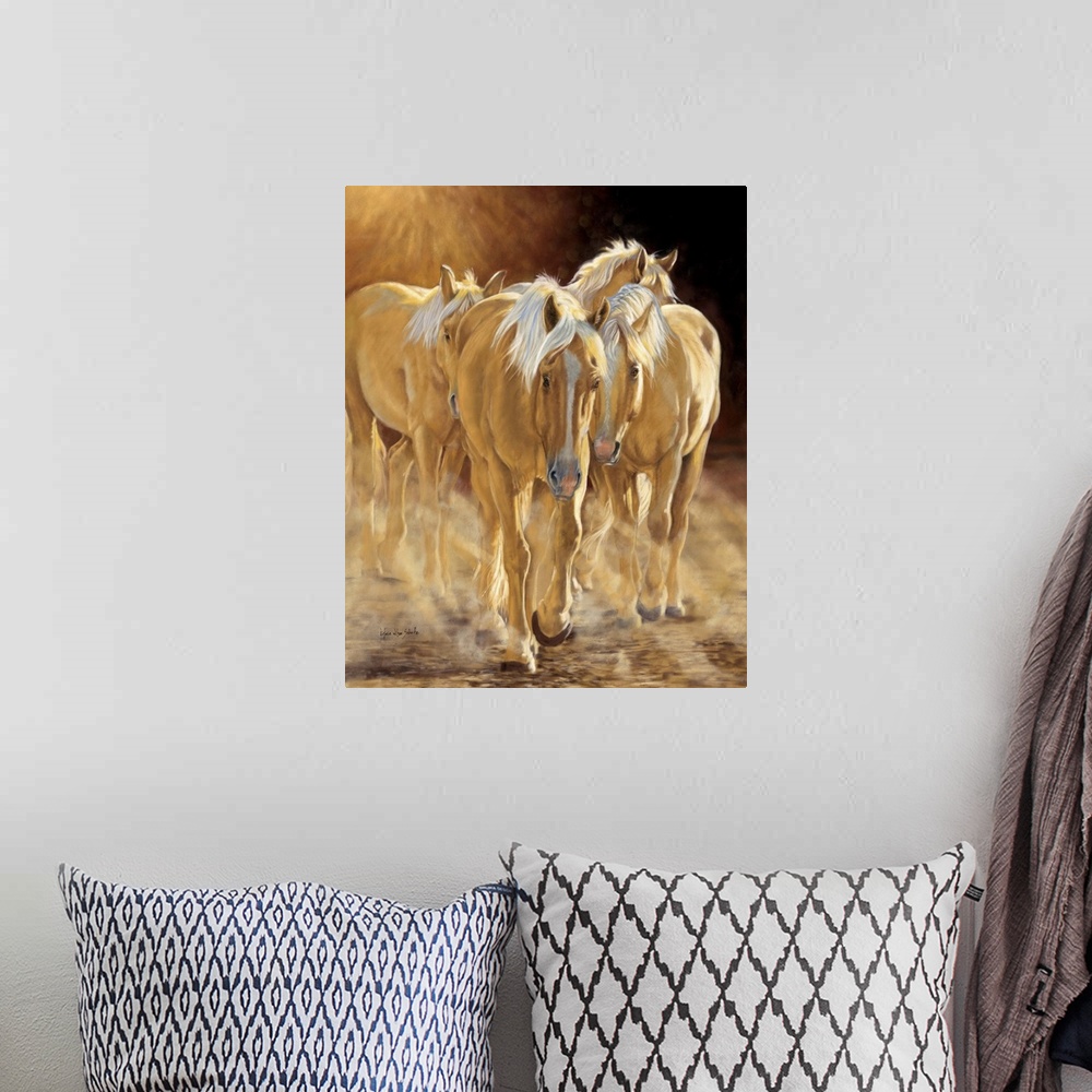 A bohemian room featuring A herd of palomino horses walking in the late afternoon light.
