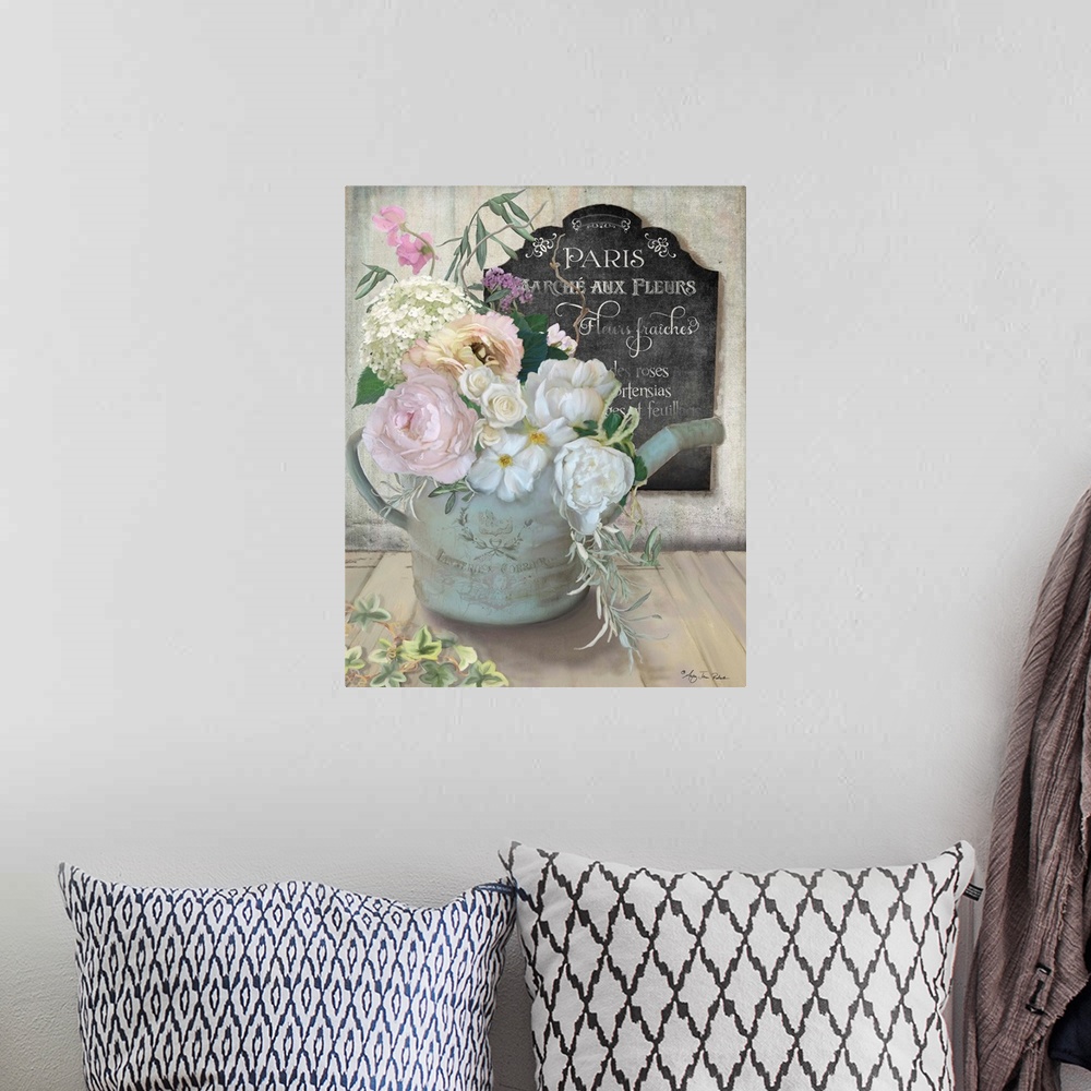 A bohemian room featuring A bouquet of roses and peonies in an old watering can next to a chalkboard sign.