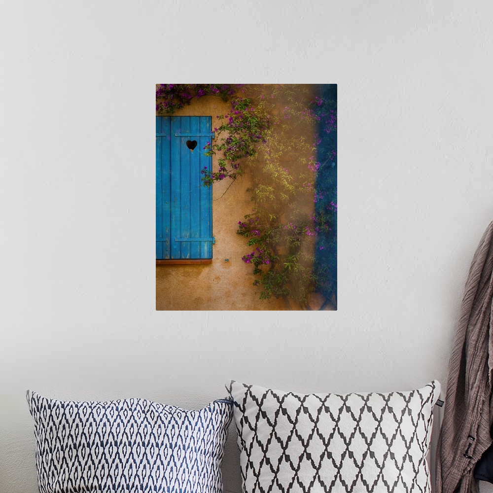 A bohemian room featuring Photograph of a French facade with a window and blue wooden shutters framed by a vine with little...