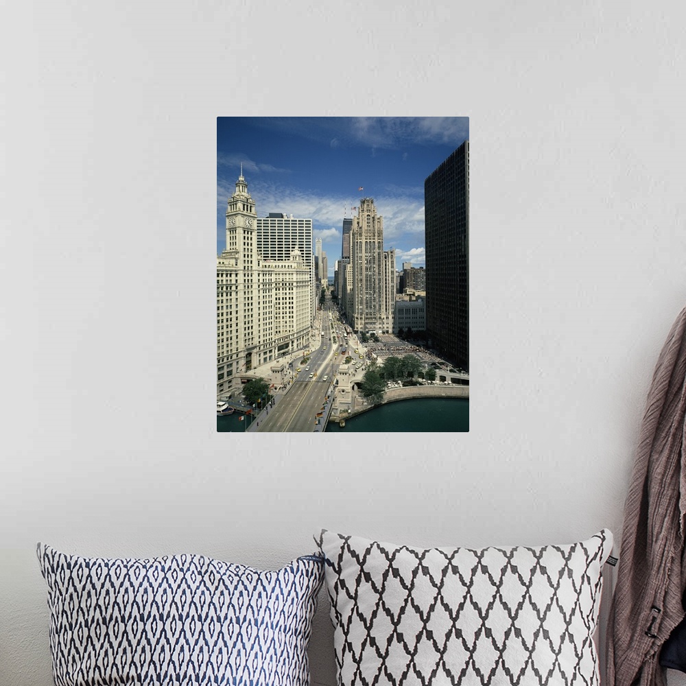 A bohemian room featuring A large vertical piece of a bridge and street running through tall buildings in the city of Chicago.