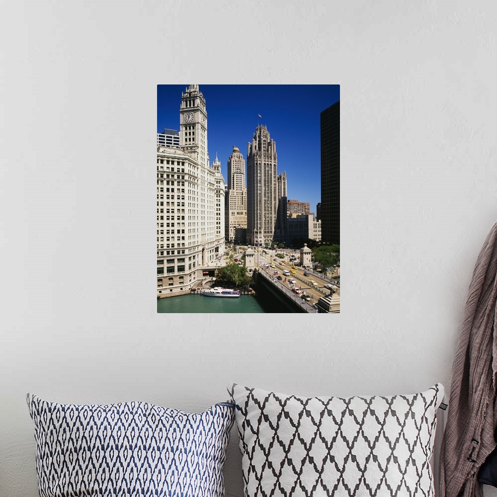 A bohemian room featuring Tall skyscraper buildings in downtown Chicago along the river as cars hustle about the busy streets.