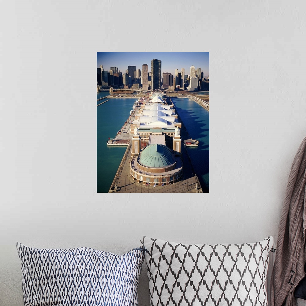 A bohemian room featuring A vertical photograph of a pier that juts out into Lake Michigan with a large pavilion built on t...
