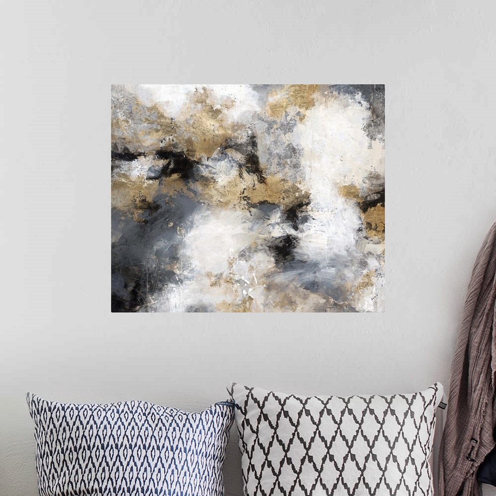 A bohemian room featuring Contemporary abstract artwork in shades of gold, grey, and white, resembling a stormy sky.