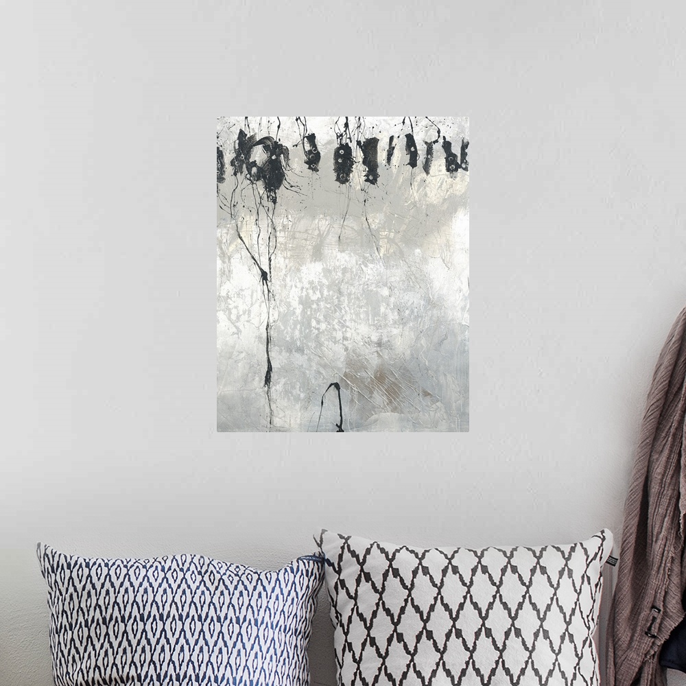 A bohemian room featuring Large black, gray, and white abstract painting with faint pale yellow hues at the top underneath ...
