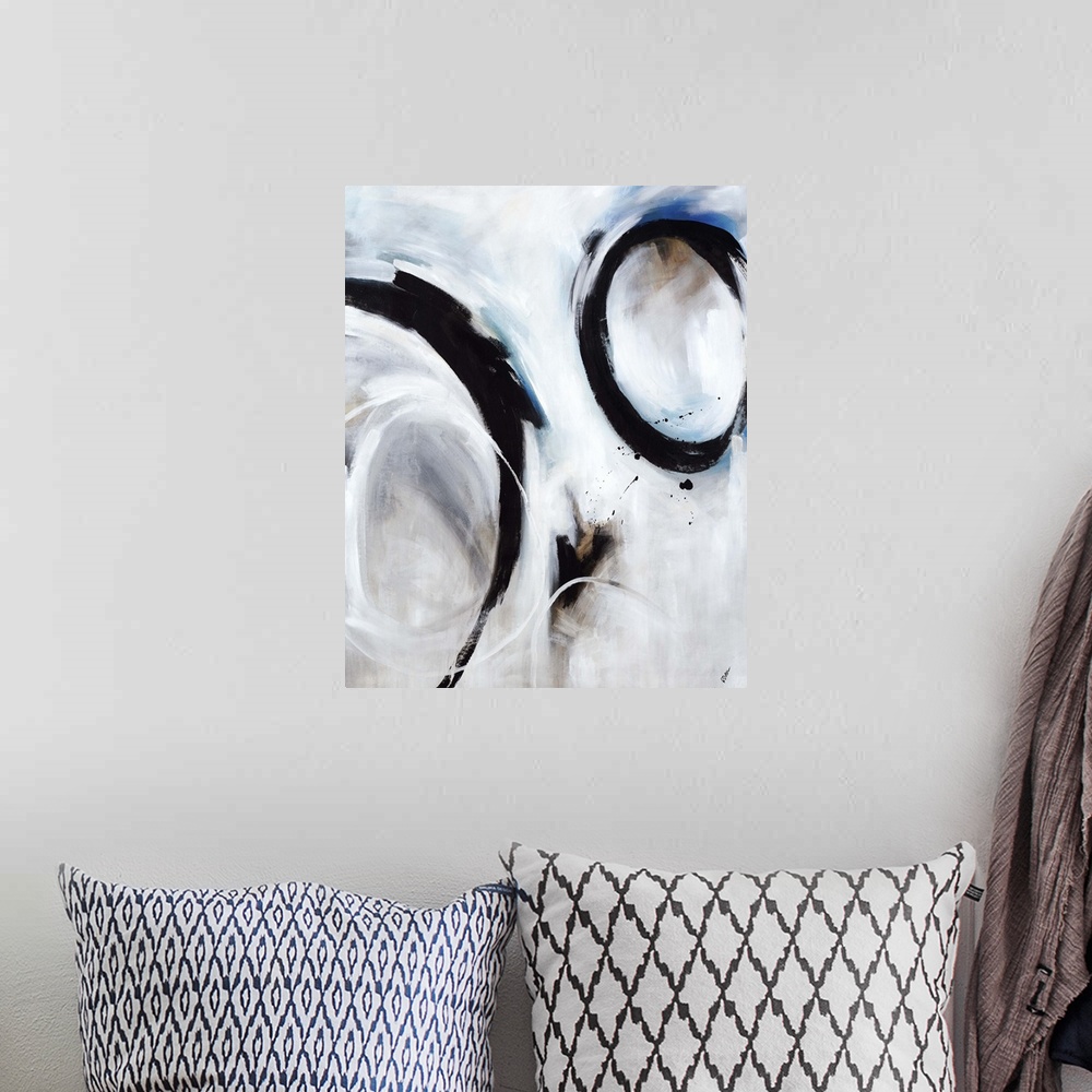 A bohemian room featuring Abstract artwork of strong black circular strokes over a soft blue and grey background.